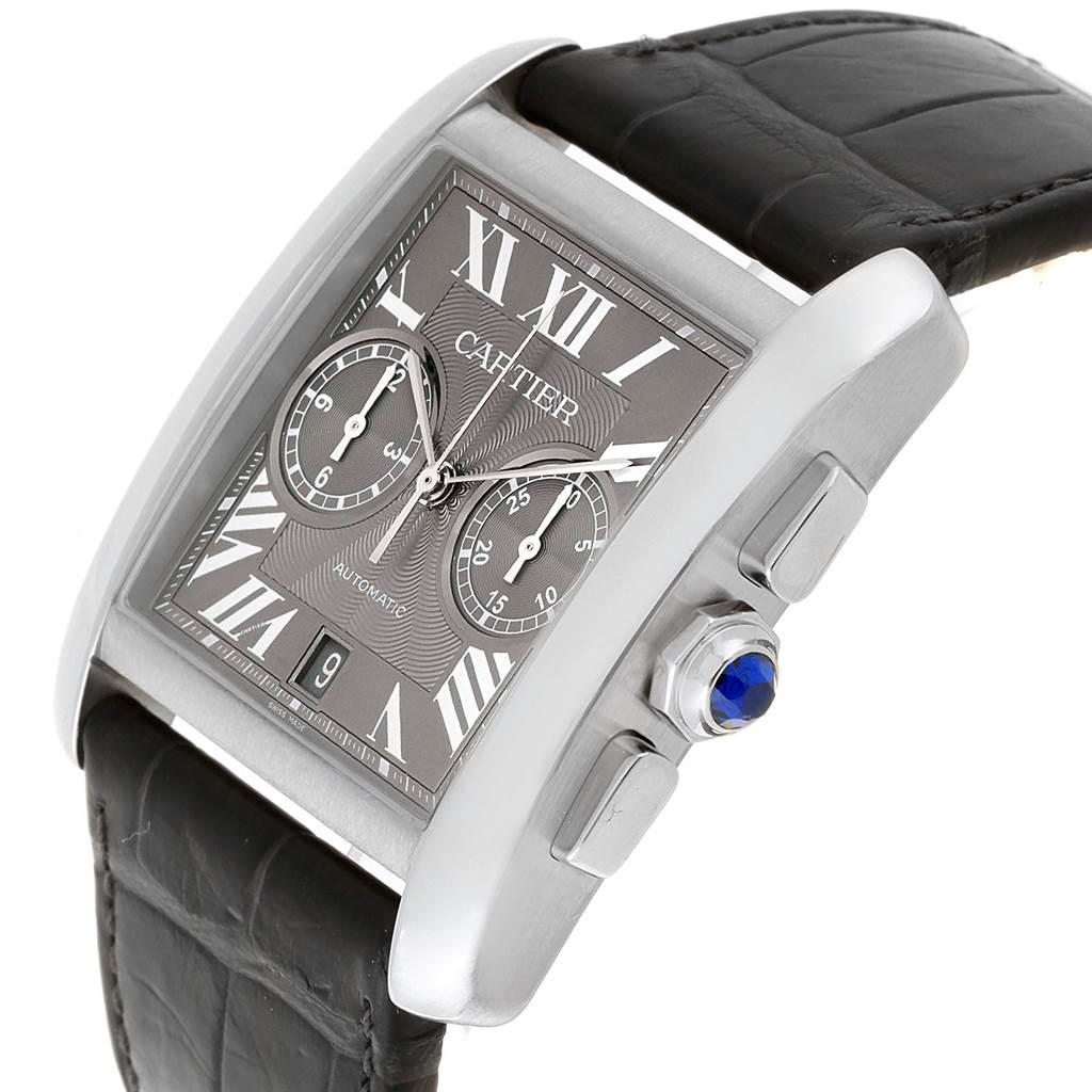 The watch is a Cartier Tank MC W5330008 Men's Stainless Steel Grey Dial W5330008 Men's Stainless Steel Grey Dial model shown at an angled view, displaying the face, crown with a blue cabochon, and part of the strap.
