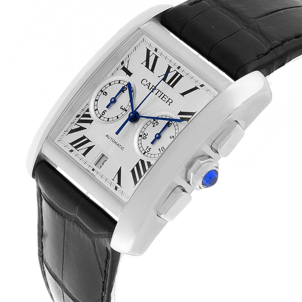 The image shows a Cartier Tank MC W5330007 Men's Stainless Steel Silver Dial W5330007 Men's Stainless Steel Silver Dial watch angled to highlight the face, crown with blue gemstone, and part of the black leather strap.