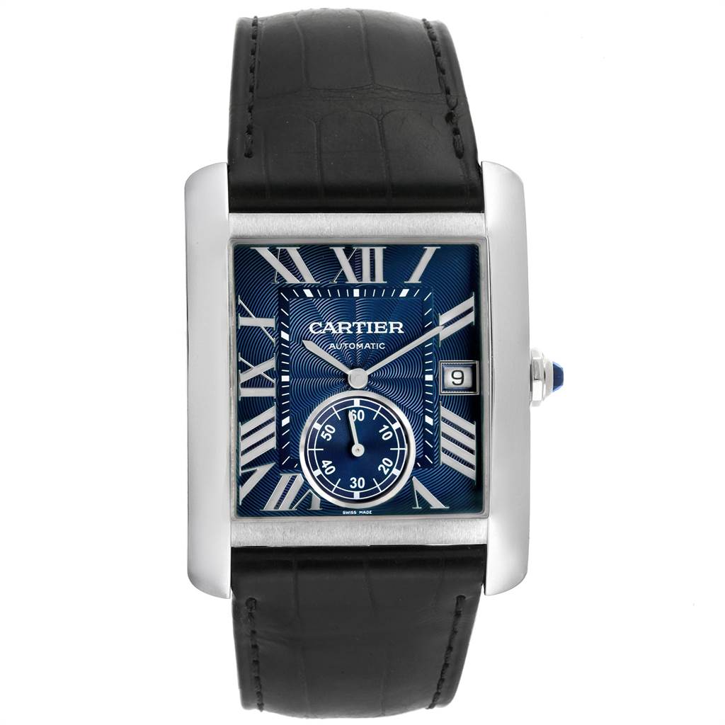 The Tank MC model by Cartier is shown from a front angle, displaying the face, Roman numerals, date window, and strap.