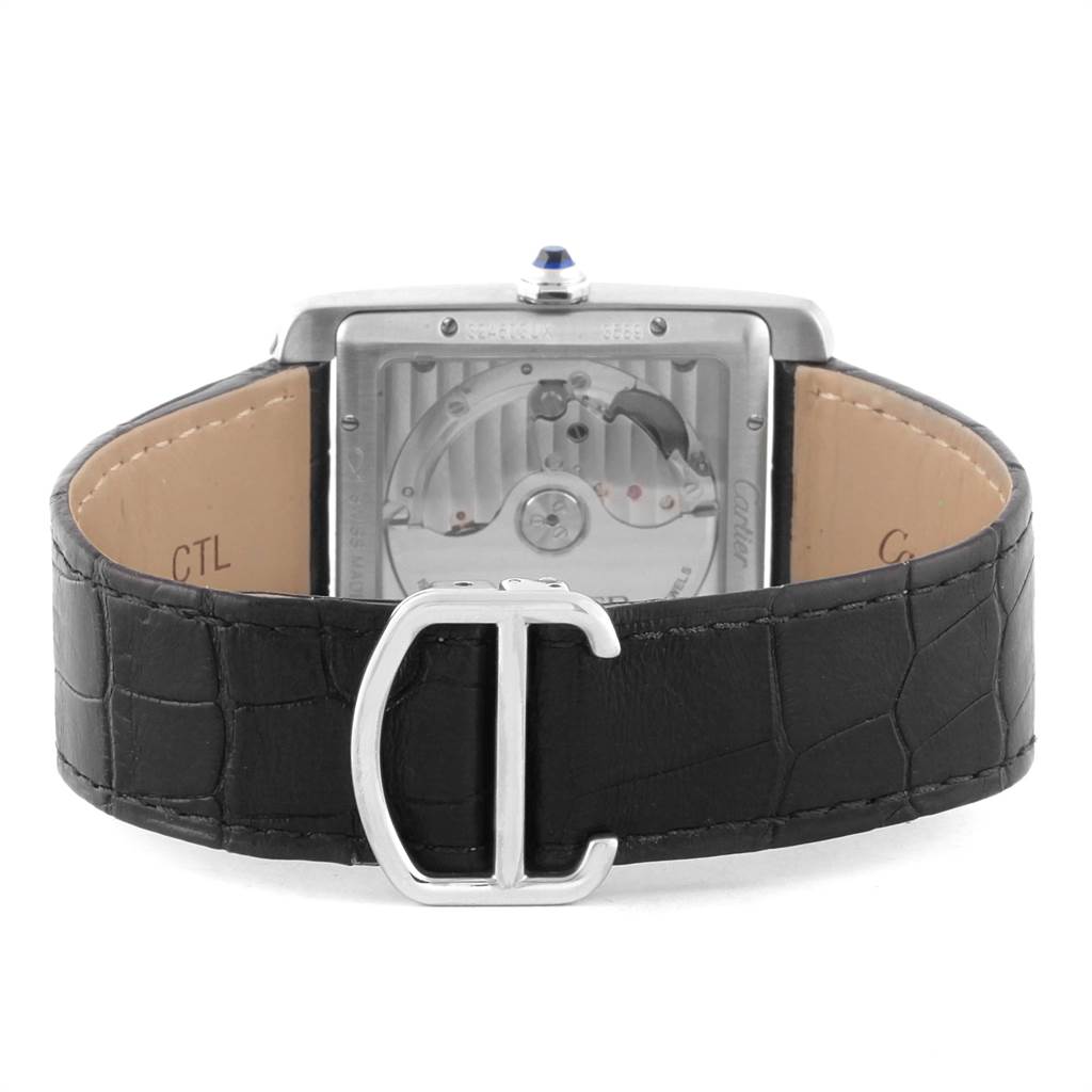 The image shows the back of a Cartier Tank MC W5330003 Men's Stainless Steel Silver Dial W5330003 Men's Stainless Steel Silver Dial watch, featuring its movement and part of the black leather strap with a "C" buckle.