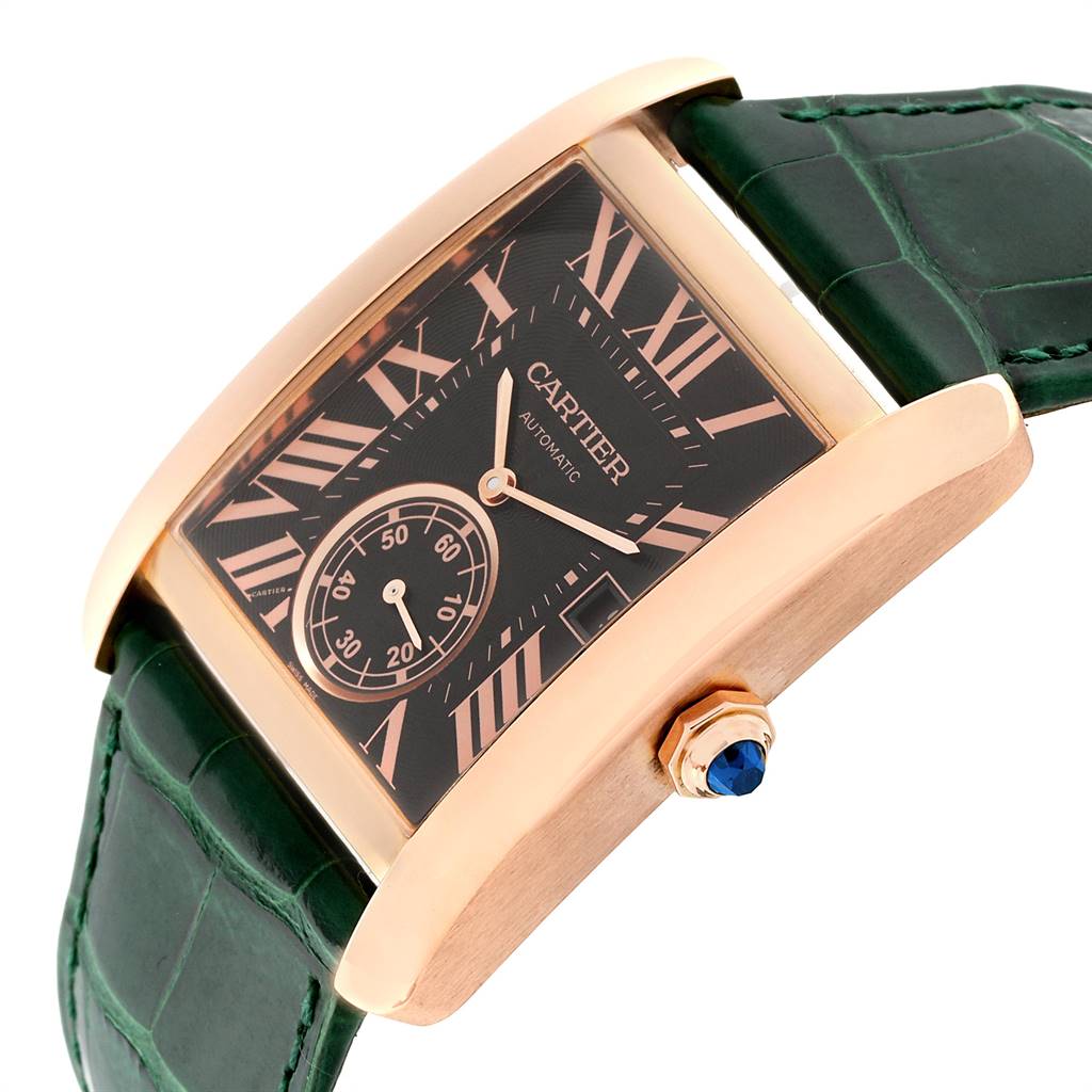 This image shows the Cartier Tank MC W5330002 Men's Rose Gold Brown Dial W5330002 Men's Rose Gold Brown Dial watch at an angle highlighting its face, green leather strap, and side crown with a blue gemstone.