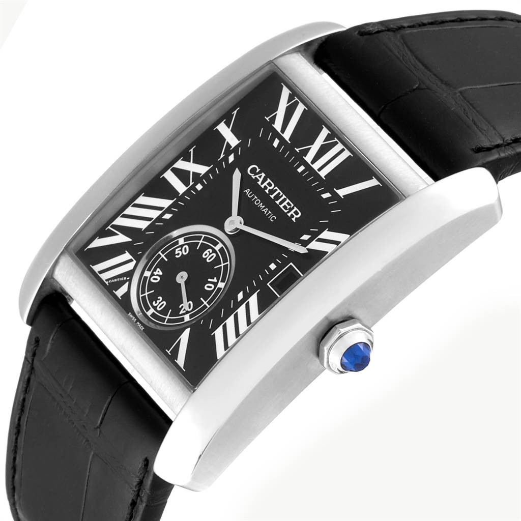 The Tank MC model by Cartier is shown at an angle highlighting its black strap, rectangular dial, and crown with blue gemstone.