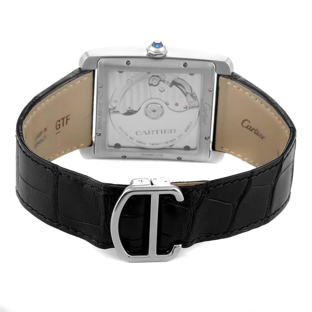 The image shows the back view of a Cartier Tank MC W5330004 Men's Stainless Steel Black Dial W5330004 Men's Stainless Steel Black Dial watch, highlighting its movement and black leather strap with a deployment clasp.