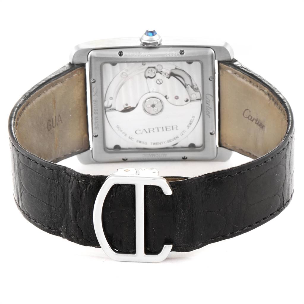 The image shows the back view of the Cartier Tank MC W5330003 Stainless Steel Silver Dial W5330003 Stainless Steel Silver Dial watch, highlighting its movement and leather strap with a clasp.