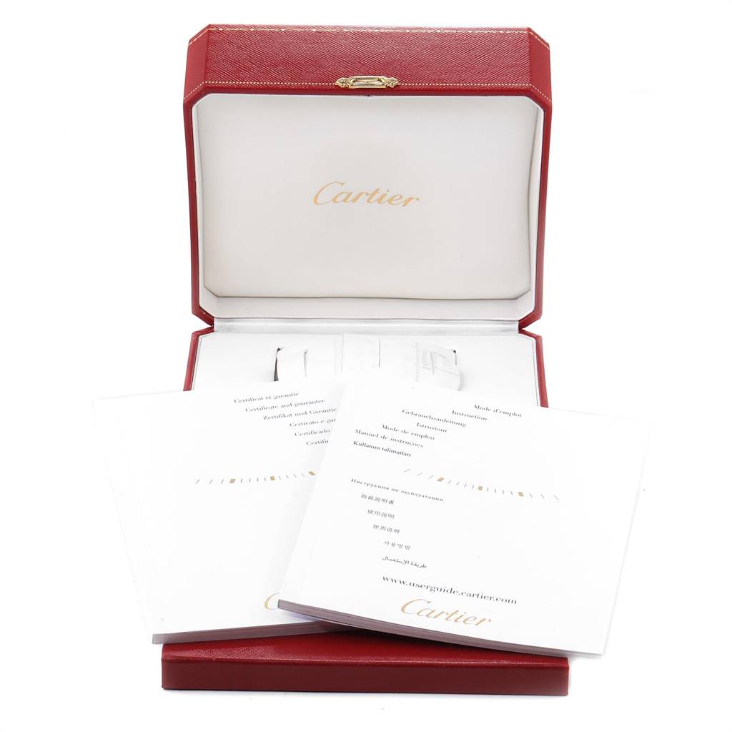 This image shows an open Cartier box for a Tank MC model, along with pamphlets and documentation inside.