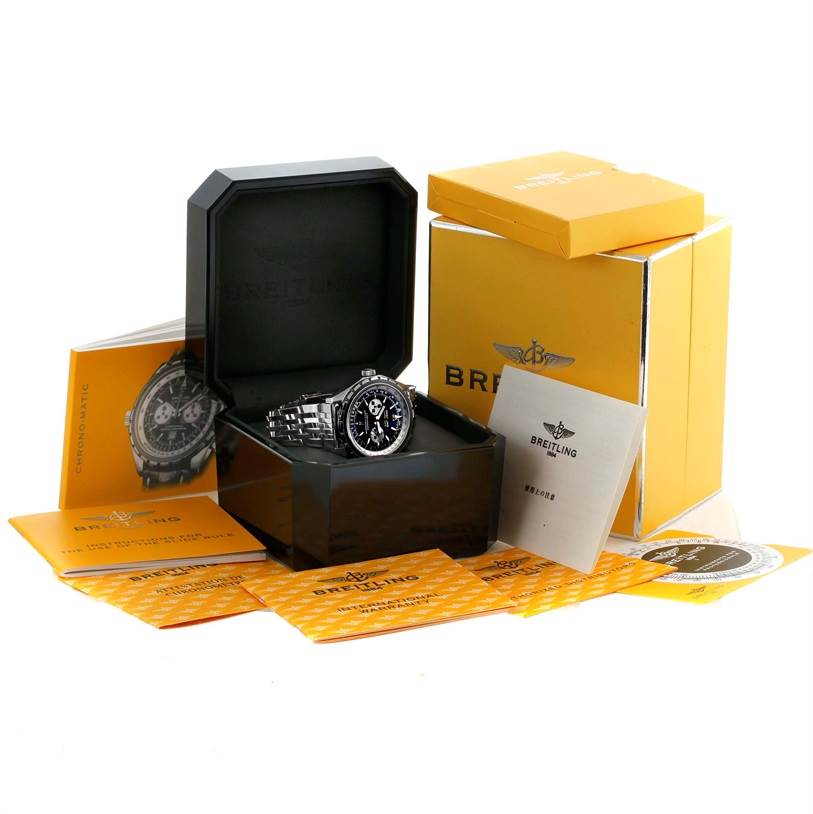 The image shows a Breitling Chronomatic A41360 Men's Stainless Steel Black Dial A41360 Men's Stainless Steel Black Dial model watch in its case, surrounded by yellow boxes, manuals, and warranty cards.