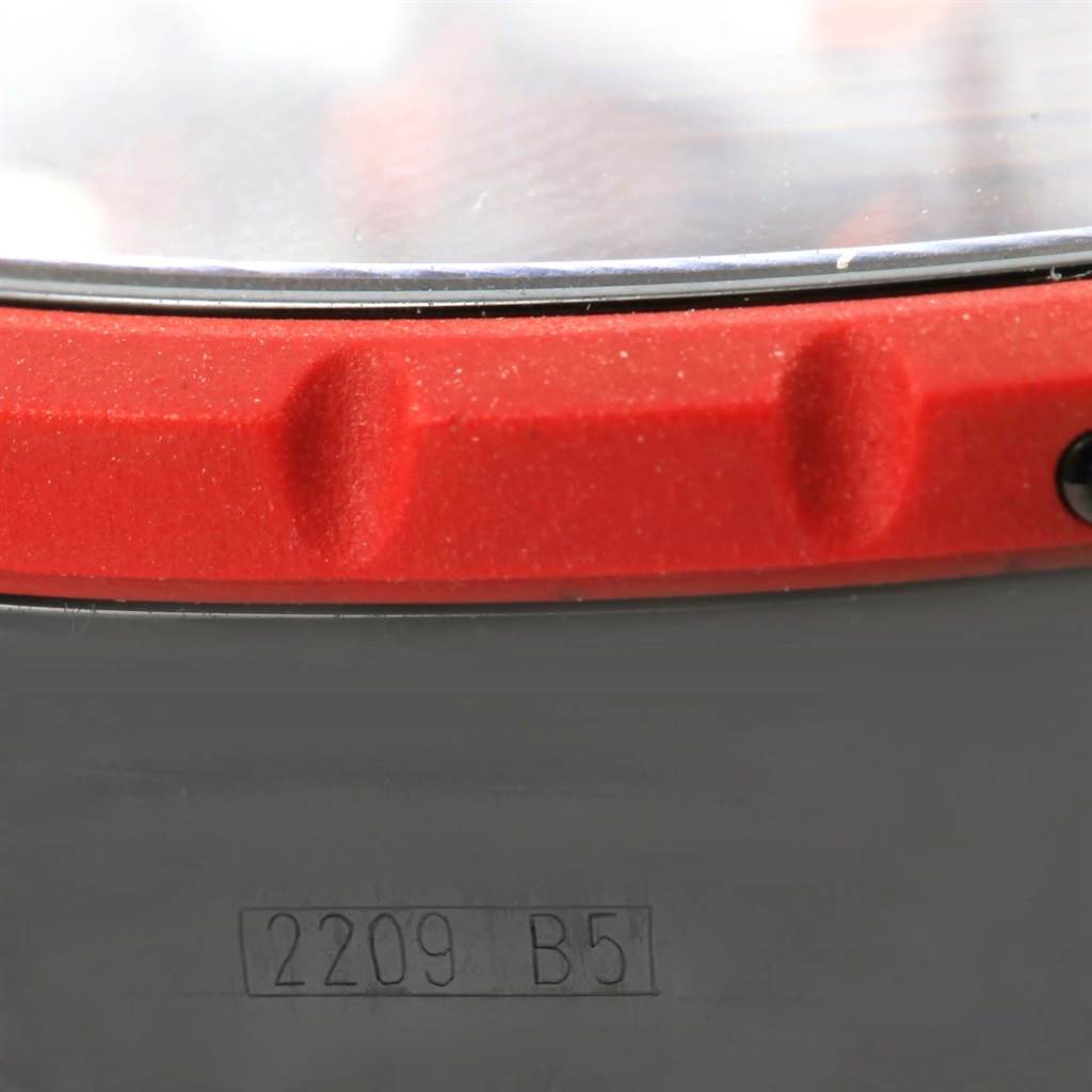 The image shows a close-up view of the bezel and case of the Breitling Chronomatic M14360 Men's Stainless Steel Black Dial M14360 Men's Stainless Steel Black Dial watch, along with part of the watch's serial number.