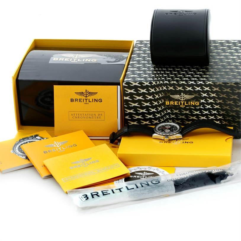 The image shows the Breitling Chronomatic A41360 Men's Stainless Steel Black Dial A41360 Men's Stainless Steel Black Dial watch, its boxes, manuals, and accessories from a frontal angle.