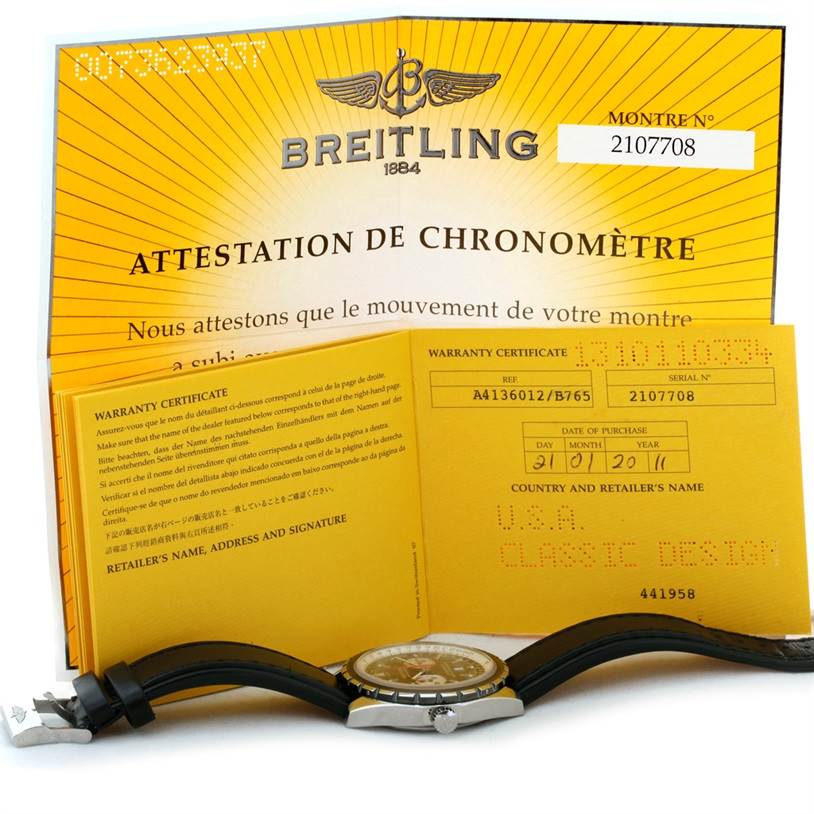 The image shows a Breitling Chronomatic A41360 Men's Stainless Steel Black Dial A41360 Men's Stainless Steel Black Dial watch from a side angle, along with its warranty certificate and chronometer attestation.