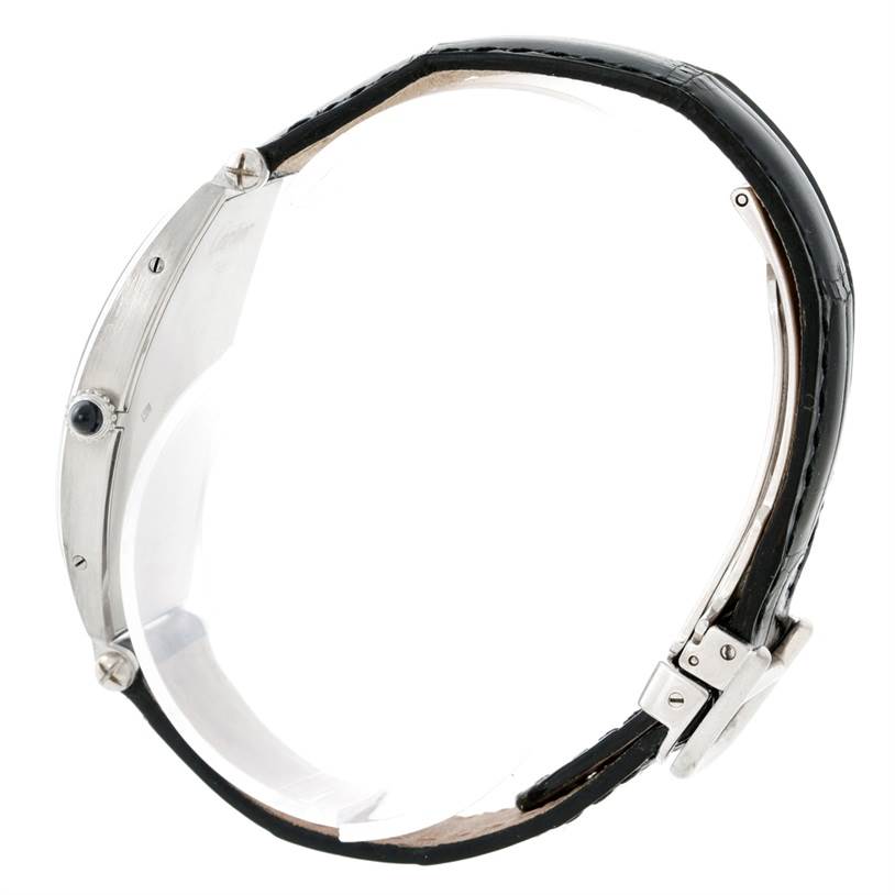 The Cartier Tonneau W1546351 Women's Platinum Silver Dial W1546351 Women's Platinum Silver Dial model watch is shown from a side profile, highlighting the case, crown, and half of the leather strap with clasp.