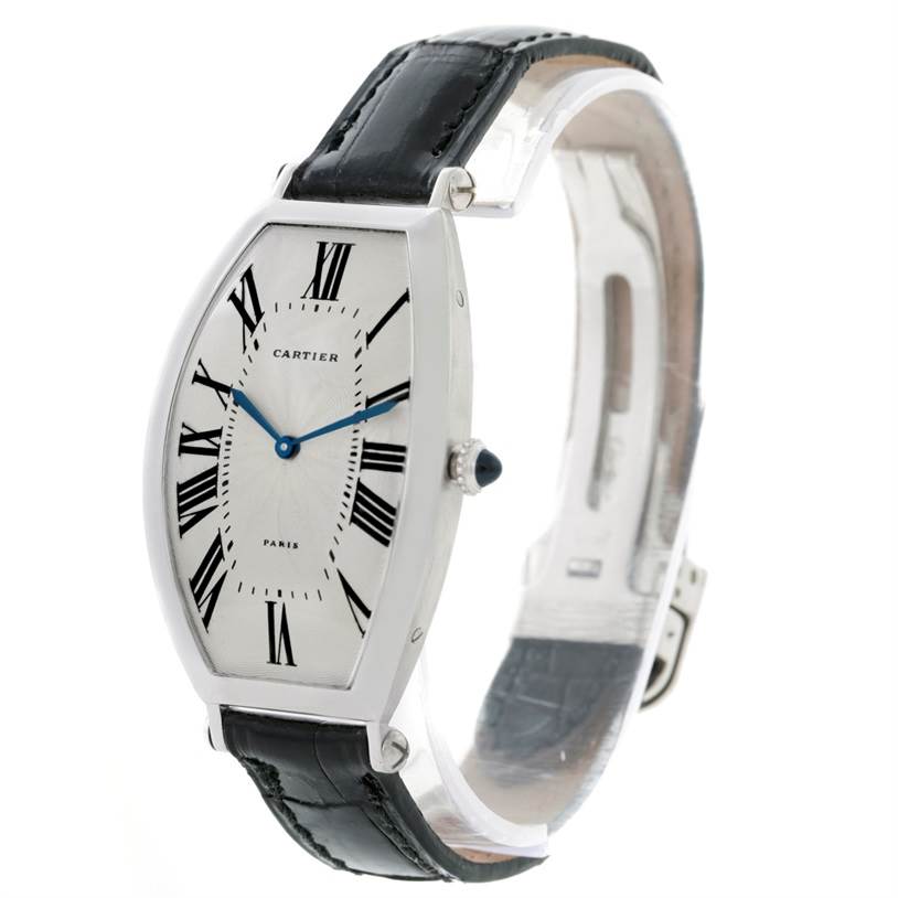The Cartier Tonneau W1546351 Women's Platinum Silver Dial W1546351 Women's Platinum Silver Dial watch is shown from a front-left angle, highlighting its dial, hands, case, and leather strap.