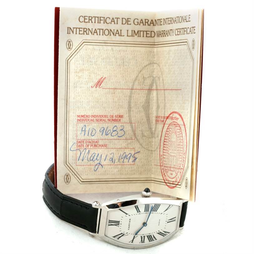 The image shows a Cartier Tonneau W1546351 Women's Platinum Silver Dial W1546351 Women's Platinum Silver Dial watch displayed with its international warranty certificate.