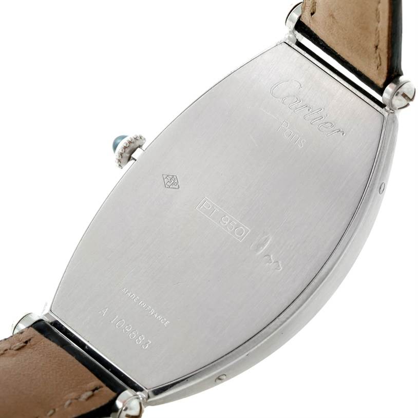 The image shows the back case of a Cartier Tonneau W1546351 Women's Platinum Silver Dial W1546351 Women's Platinum Silver Dial watch, including part of the leather strap and the crown with a blue gem.
