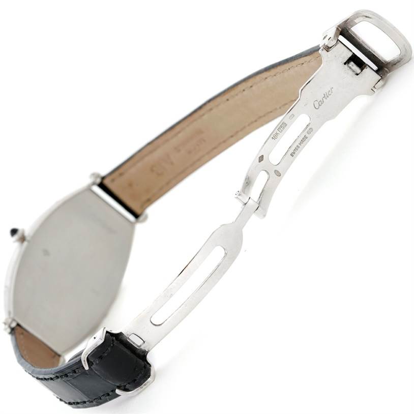 The image shows a side angle of a Cartier Tonneau W1546351 Women's Platinum Silver Dial W1546351 Women's Platinum Silver Dial model watch, focusing on the back case and partially open leather strap with the Cartier brand visible.