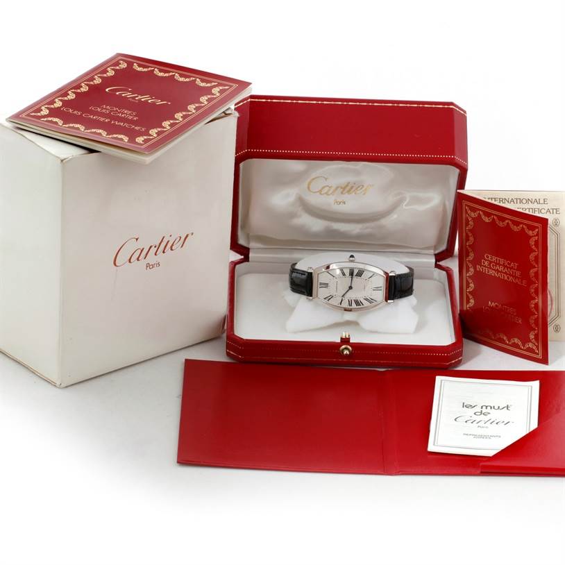 The image shows a Cartier Tonneau W1546351 Women's Platinum Silver Dial W1546351 Women's Platinum Silver Dial watch with its red presentation box, outer cardboard box, and accompanying documents.