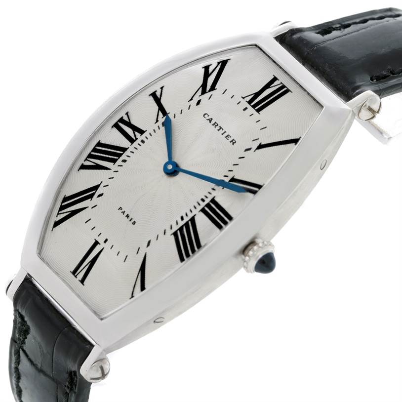This image shows a close-up of the Cartier Tonneau W1546351 Women's Platinum Silver Dial W1546351 Women's Platinum Silver Dial watch's face, crown, and part of the leather strap at an angled, three-quarter view.