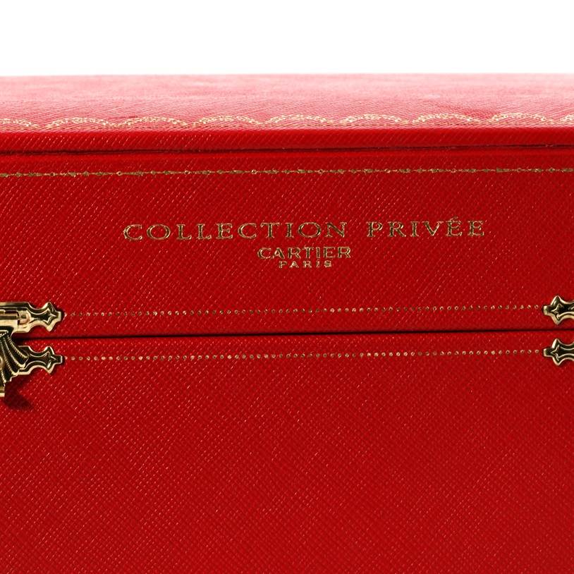 The image shows a Cartier "Collection Privée" red watch box, likely for a Tank A Vis model, featuring gold accents and lettering.