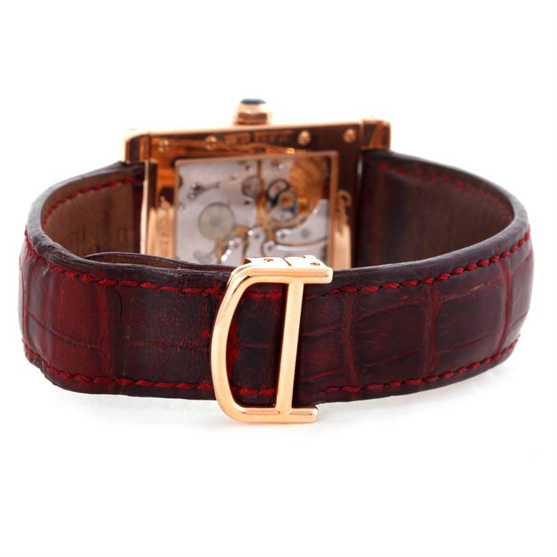 The image shows the back view of a Cartier Tank A Vis W1537651 Men's Rose Gold Silver Dial W1537651 Men's Rose Gold Silver Dial watch, highlighting its open caseback and leather strap.