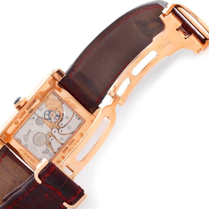 This image shows the back view of a Cartier Tank A Vis W1537651 Men's Rose Gold Silver Dial W1537651 Men's Rose Gold Silver Dial watch, highlighting its movement mechanism and partially opened leather strap.