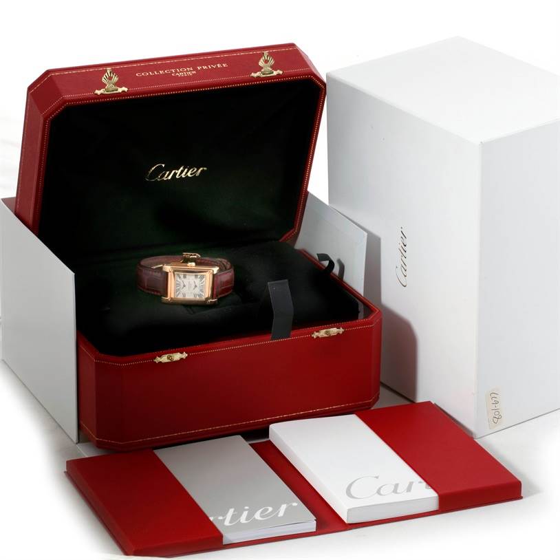 The image shows a Cartier Tank A Vis W1537651 Men's Rose Gold Silver Dial W1537651 Men's Rose Gold Silver Dial watch in an open red box with booklets and outer packaging.