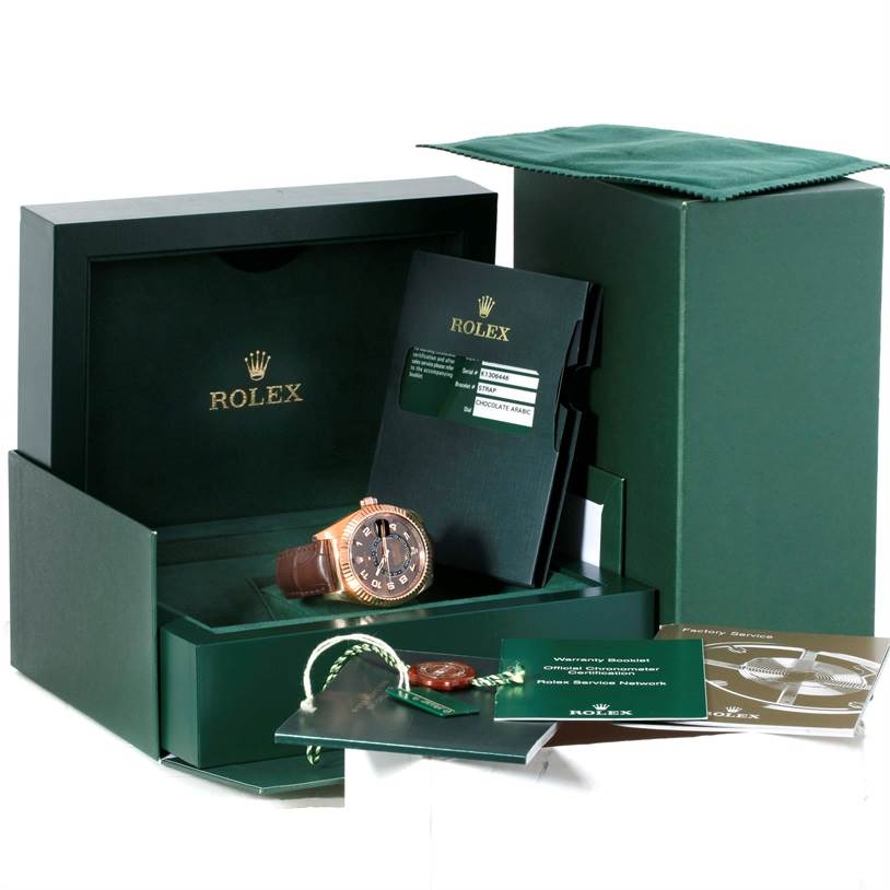 The image shows a Rolex Sky-Dweller 326135 Men
s Rose Gold Brown Dial 326135 Men
s Rose Gold Brown Dial watch, with its original box, warranty card, tag, booklet, and documents.