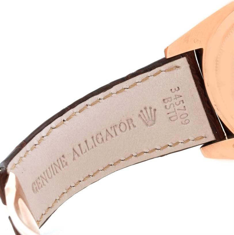 The image shows the back side of the strap and part of the case of a Rolex Sky-Dweller 326135 Men
s Rose Gold Brown Dial 326135 Men
s Rose Gold Brown Dial watch, highlighting the genuine alligator leather band.