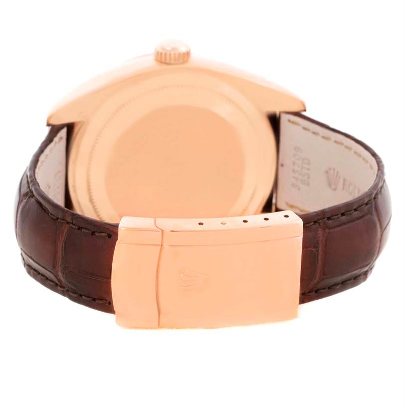 The image shows the back of a Rolex Sky-Dweller 326135 Men
s Rose Gold Brown Dial 326135 Men
s Rose Gold Brown Dial watch, focusing on the case back and the clasp of the leather strap.