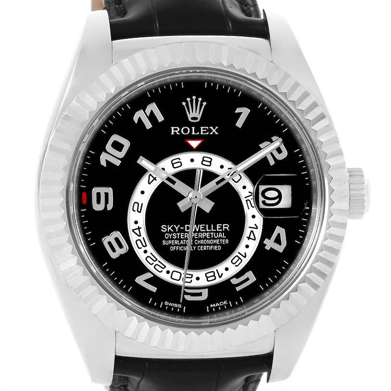 The image shows a front view of the Rolex Sky-Dweller watch, detailing its black dial, fluted bezel, and date display.