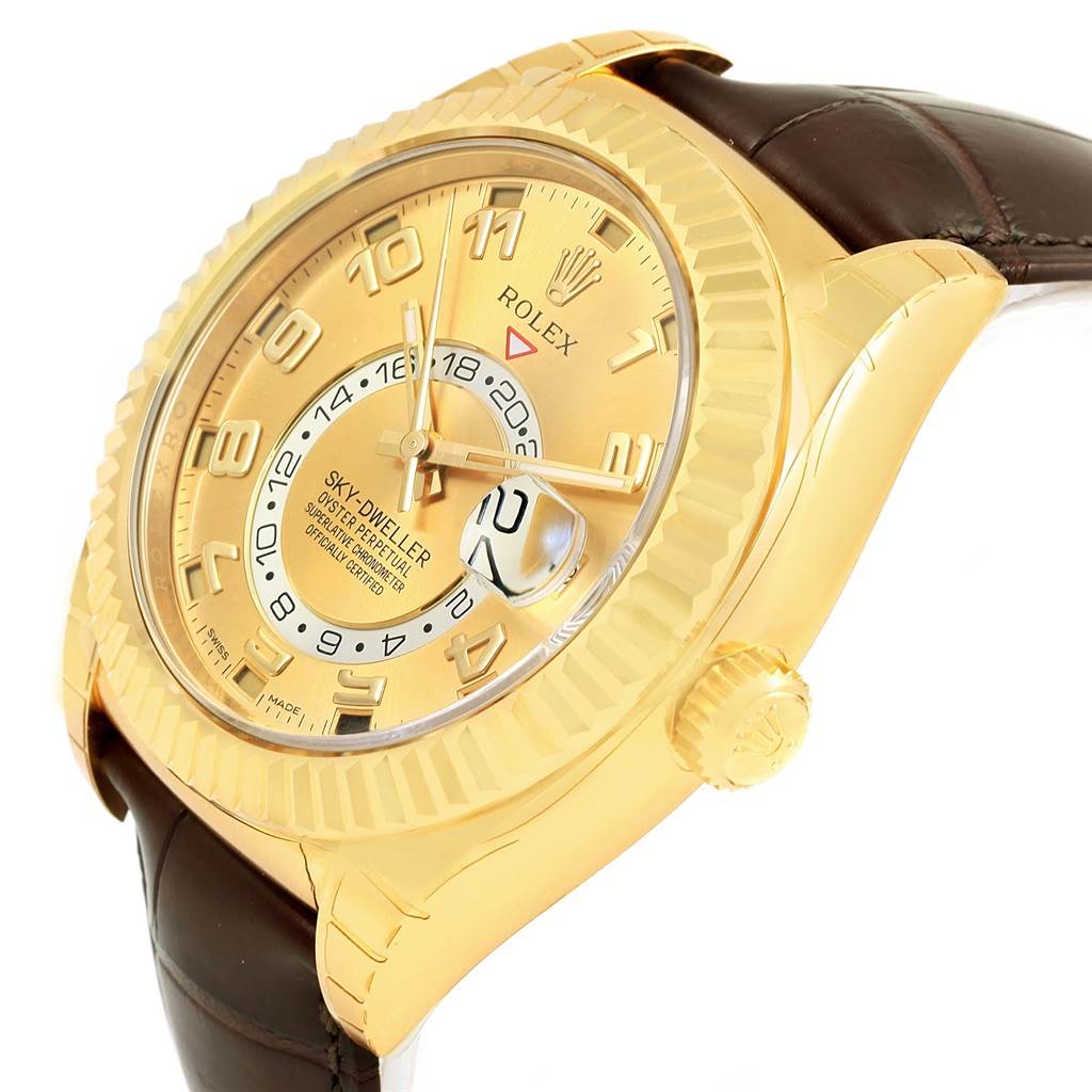 This image displays a Rolex Sky-Dweller 326138 Men's Yellow Gold Champagne Dial 326138 Men's Yellow Gold Champagne Dial watch at an oblique angle, showcasing its gold-tone face, fluted bezel, and leather strap.