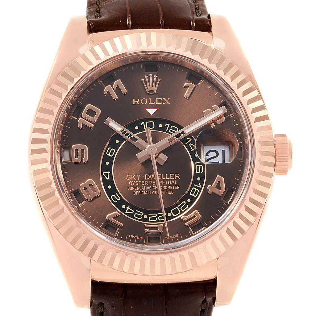 The image shows a front view of the Rolex Sky-Dweller 326135 Men's Rose Gold Brown Dial 326135 Men's Rose Gold Brown Dial watch, highlighting its dial, bezel, and partially the leather strap.