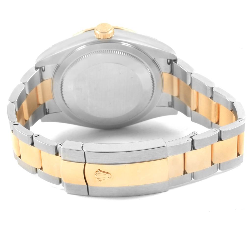 This image shows the back case and two-tone bracelet of a Rolex Sky-Dweller 326933 Men's Steel and Gold (two tone) White Dial 326933 Men's Steel and Gold (two tone) White Dial, including the clasp with the Rolex logo.
