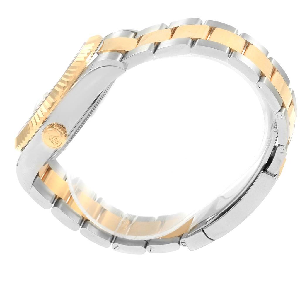 This side view showcases the strap, crown, and bezel of the gold and silver Rolex Sky-Dweller 326933 Men's Steel and Gold (two tone) White Dial 326933 Men's Steel and Gold (two tone) White Dial watch.