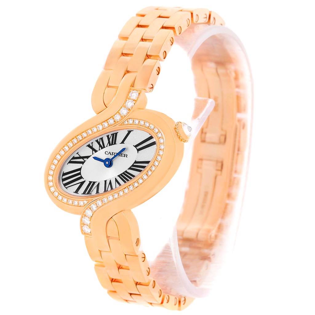 The image shows a side-angle view of the Cartier Delices WG800003 Women's Rose Gold Silver Dial WG800003 Women's Rose Gold Silver Dial model watch featuring its elliptical dial, gold bracelet, and diamond accents.
