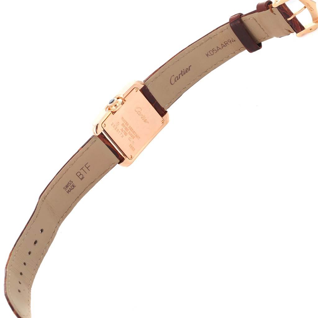 This Cartier Tank Anglaise WT100024 Women
s Rose Gold Silver Dial WT100024 Women
s Rose Gold Silver Dial watch is shown from the back, displaying the case back, strap, and buckle.