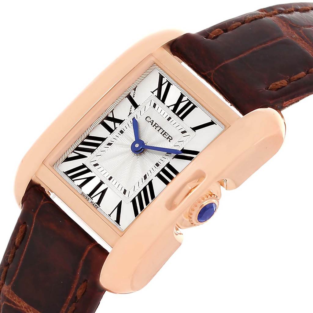 This image shows a Cartier Tank Anglaise WT100024 Women
s Rose Gold Silver Dial WT100024 Women
s Rose Gold Silver Dial watch at an angled close-up, highlighting the face, crown, and part of the leather strap.