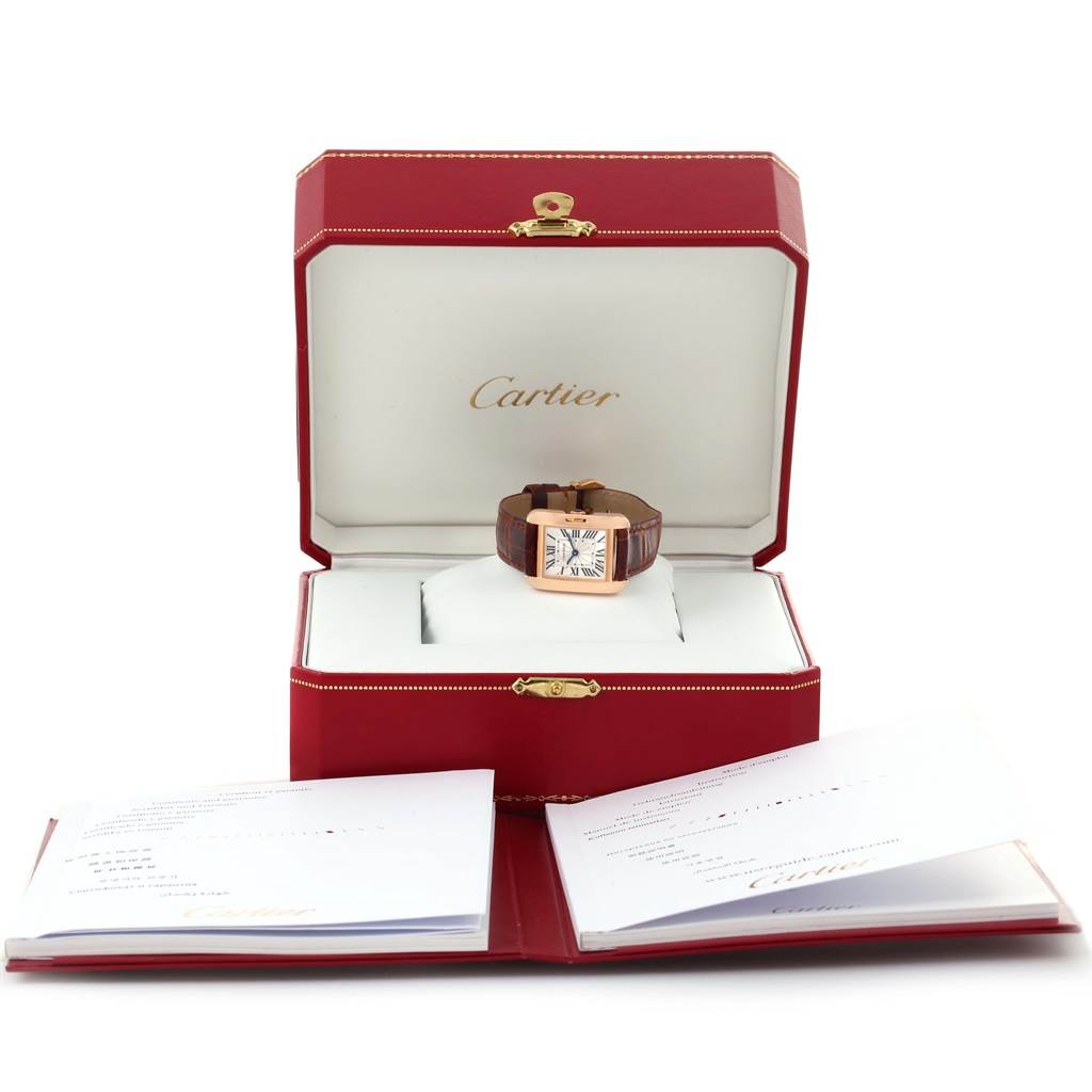 The image shows a Cartier Tank Anglaise WT100024 Women
s Rose Gold Silver Dial WT100024 Women
s Rose Gold Silver Dial watch displayed in an open red Cartier box with accompanying booklets.