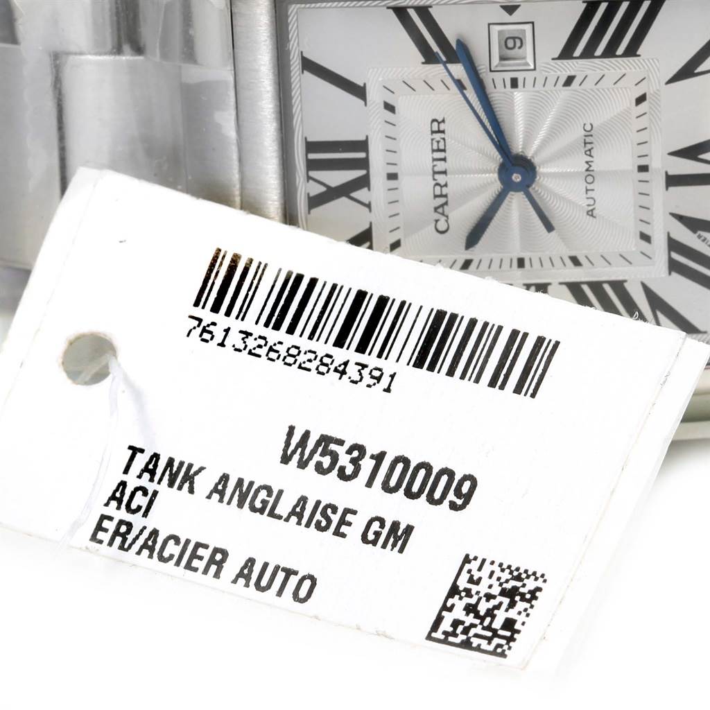 The image shows a close-up of the dial and bracelet of a Cartier Tank Anglaise W5310009 Men's Stainless Steel Silver Dial W5310009 Men's Stainless Steel Silver Dial watch along with its tag.