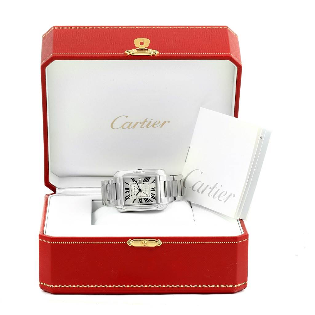 The Cartier Tank Anglaise W5310009 Men's Stainless Steel Silver Dial W5310009 Men's Stainless Steel Silver Dial watch is shown facing forward inside a red Cartier box with a booklet beside it.