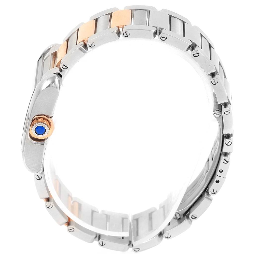 The image shows a side view of the Cartier Tank Anglaise WT100024 Women's Steel and Gold (two tone) Silver Dial WT100024 Women's Steel and Gold (two tone) Silver Dial watch, highlighting its bracelet and crown with a blue gem.