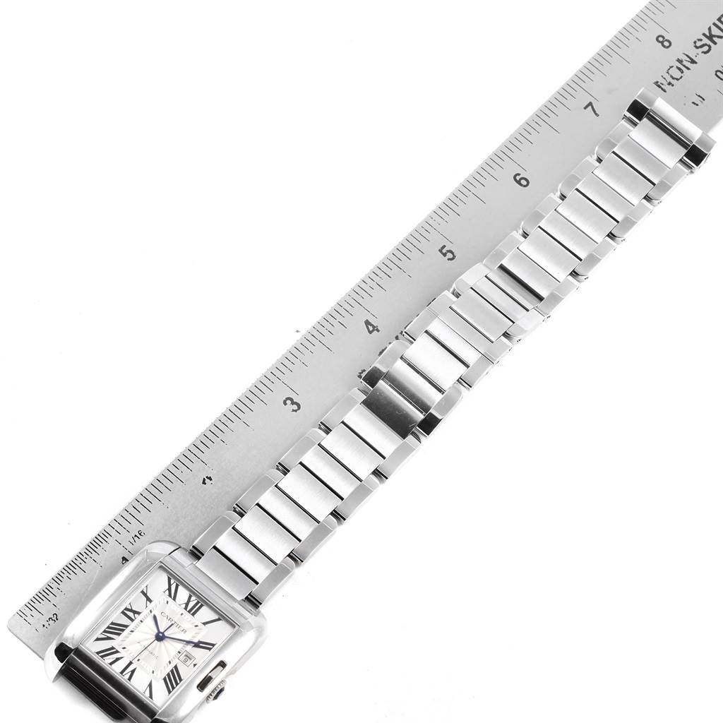 The image shows a horizontal view of the Tank Anglaise by Cartier, focusing on the face, bracelet, and clasp beside a ruler.