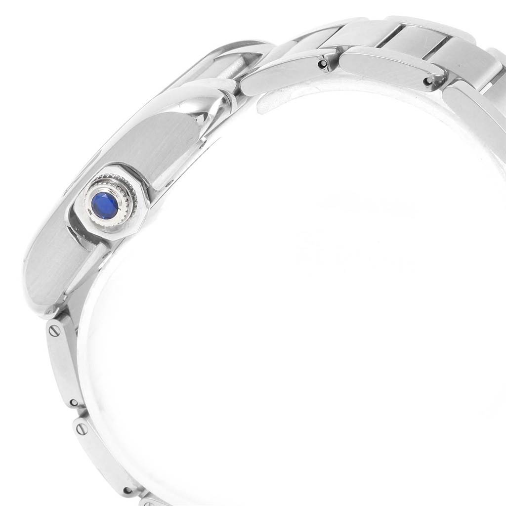 The image shows a side view of the Tank Anglaise model by Cartier, highlighting the crown with a blue gem and part of the metal bracelet.