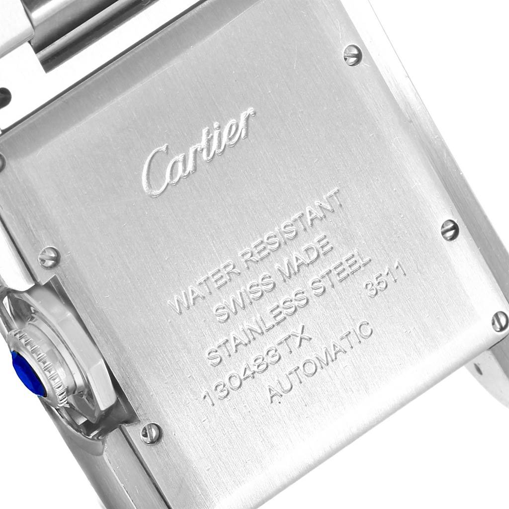 The image shows the back casing and crown of a Cartier Tank Anglaise W5310009 Men
s Stainless Steel Silver Dial W5310009 Men
s Stainless Steel Silver Dial watch, featuring engravings and a blue cabochon.
