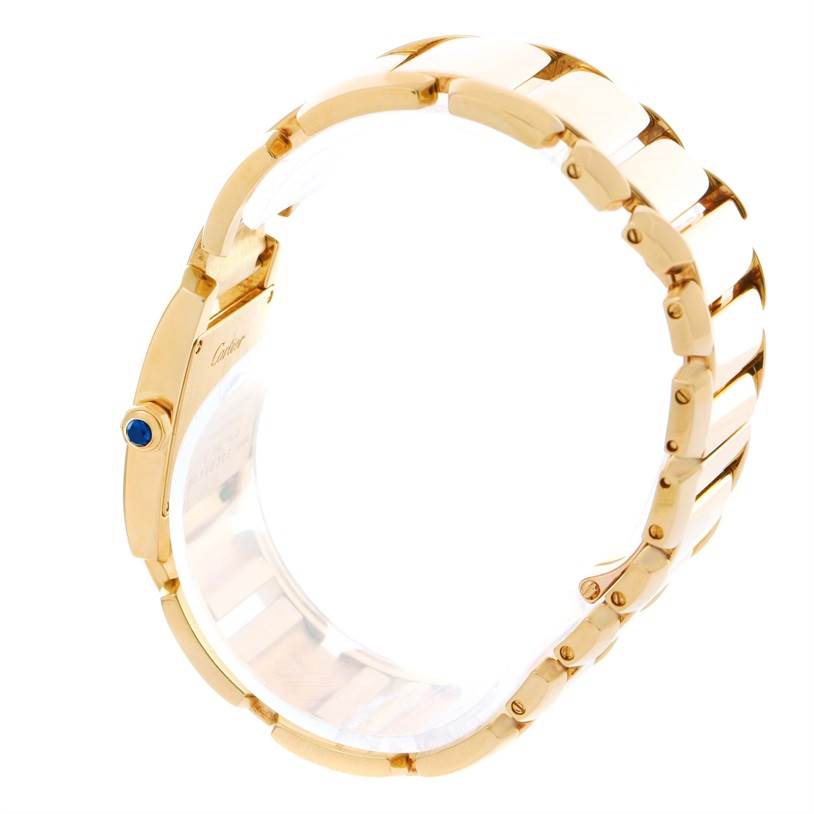 The image shows a side view of the Cartier Tankissime W650037H Women's Yellow Gold Silver Dial W650037H Women's Yellow Gold Silver Dial watch, focusing on the gold bracelet and blue crown. 