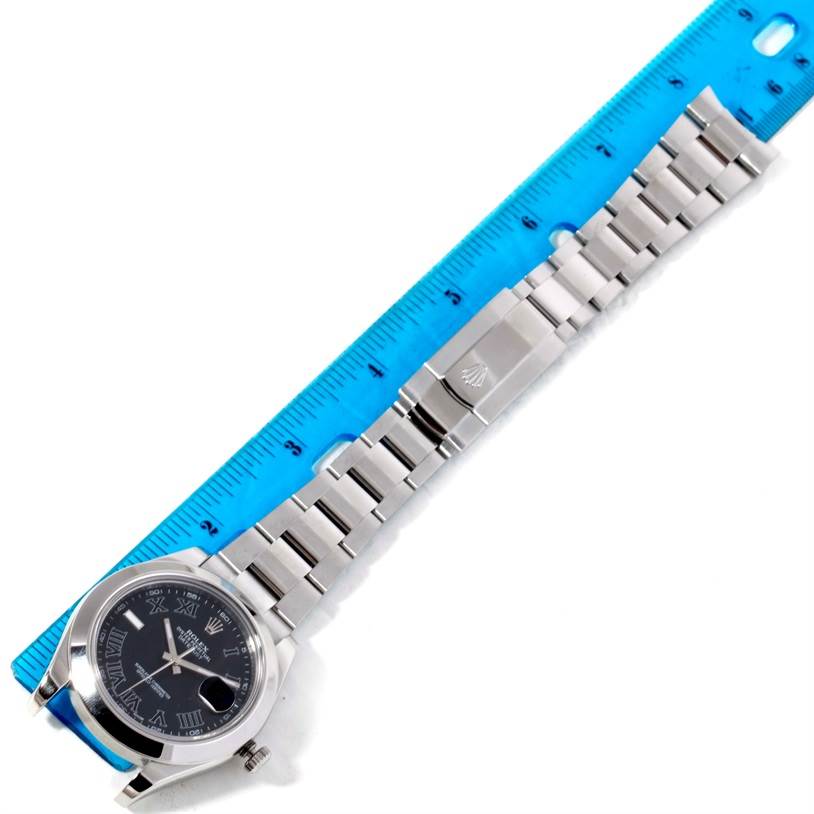 The image shows a Rolex Datejust 41 116300 Men's Stainless Steel Black Dial 116300 Men's Stainless Steel Black Dial watch laid flat, displaying the face, bracelet, and clasp next to a ruler for scale.
