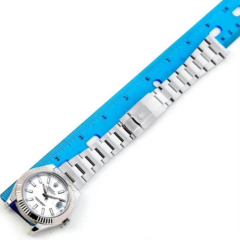 The image shows a Rolex Datejust 41 116334 Men's Stainless Steel White Dial 116334 Men's Stainless Steel White Dial watch laid flat, featuring the watch face, band, and clasp, against a blue ruler for scale.