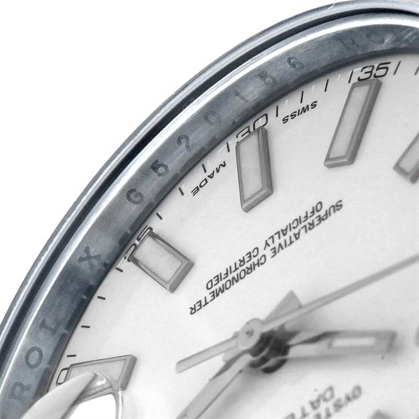 A close-up of the Rolex Datejust 41 116334 Men's Stainless Steel White Dial 116334 Men's Stainless Steel White Dial watch, showing the bezel, part of the dial, markers, and hands.
