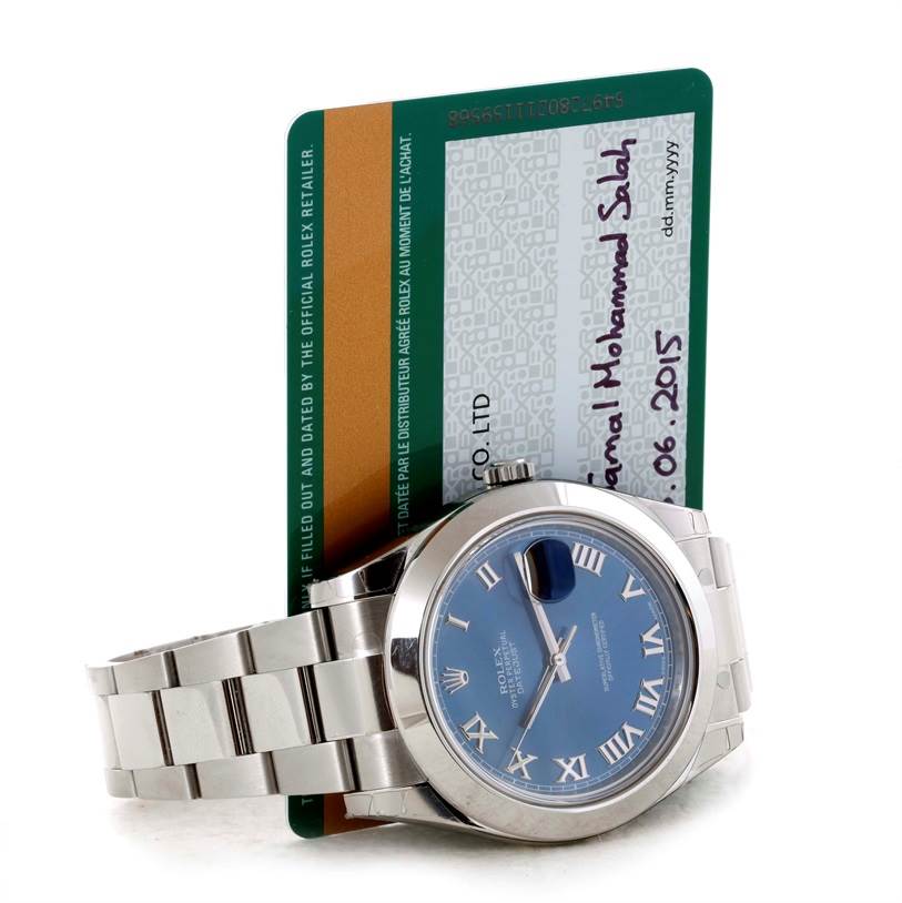 This image shows the front and bracelet of the Rolex Datejust 41 116300 Men's Stainless Steel Blue Dial 116300 Men's Stainless Steel Blue Dial, positioned against its warranty card.