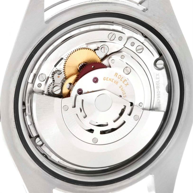 The image shows the internal mechanism of a Rolex Datejust 41 116334 Men
s Stainless Steel Grey Dial 116334 Men
s Stainless Steel Grey Dial watch, viewed from the back, displaying gears and the rotor.