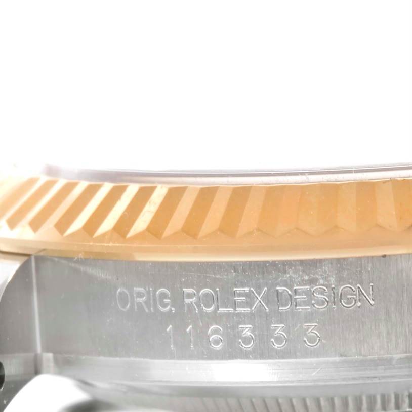 The image shows a close-up of the side of the Rolex Datejust 41 116333 Men
s Steel and Gold (two tone) Black Dial 116333 Men
s Steel and Gold (two tone) Black Dial
s case, highlighting its bezel and engraved design number.
