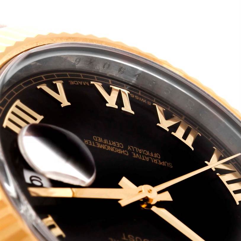 This close-up angle of the Rolex Datejust 41 116333 Men
s Steel and Gold (two tone) Black Dial 116333 Men
s Steel and Gold (two tone) Black Dial watch shows part of the dial, bezel, Roman numerals, and date magnifier.